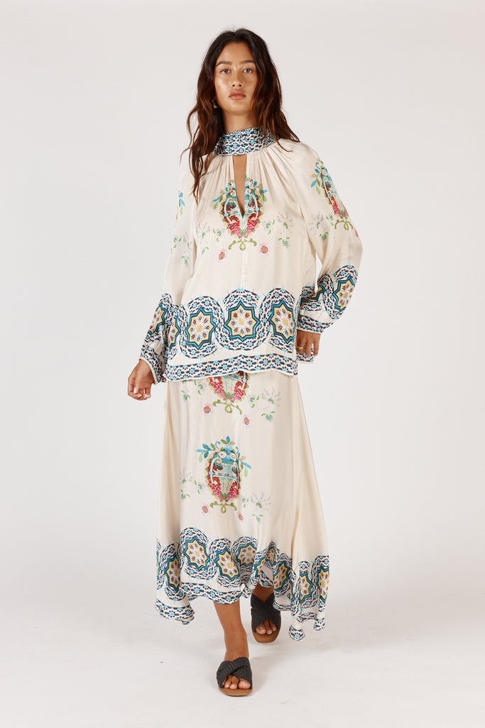 Full length front view of RubyYaya Garcia Shirt Cream with high neck, relaxed fit, and full-length sleeves