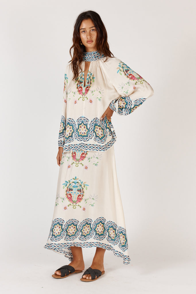 Side view of Rubyyaya Garcia Cream A-line midi skirt highlighting flow and fabric texture