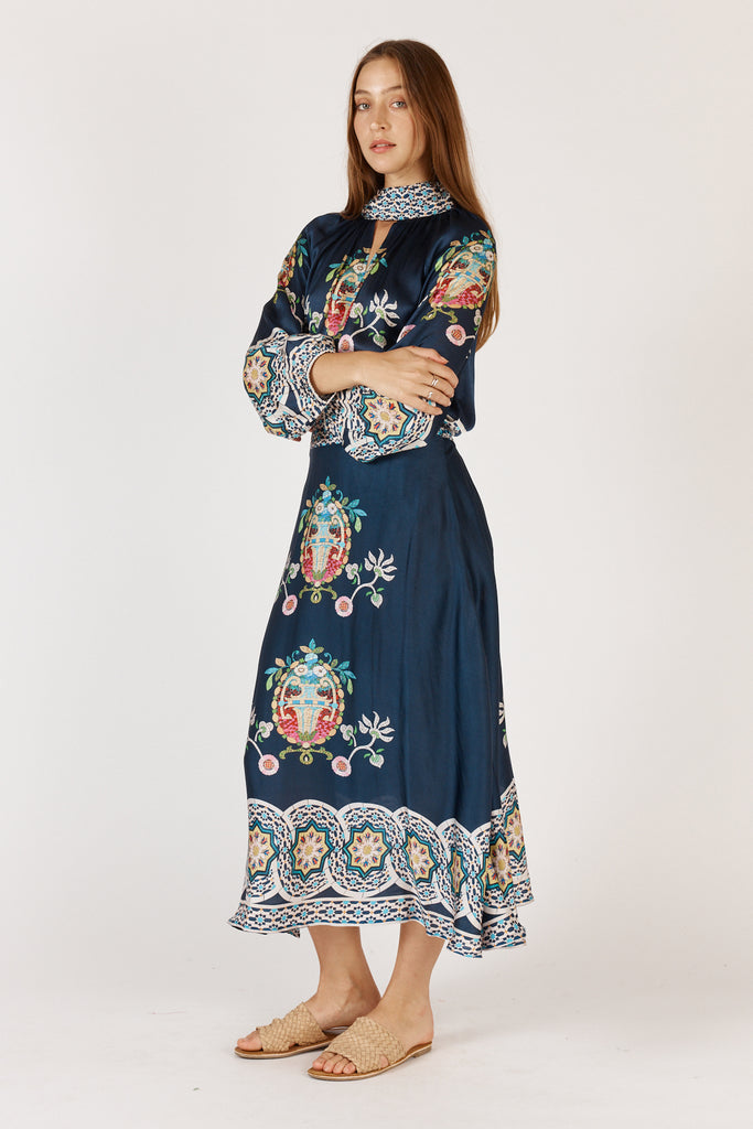 Full-length view of model wearing Rubyyaya Garcia skirt Navy styled with matching shirt.