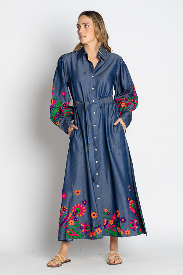 Front view of a model wearing the Rubyyaya Gokarna Maxi Dress with the belt, featuring a V-neckline, button-through style, long sleeves with elasticated cuffs, and intricate Aari embroidery on soft cotton, designed in Australia. Model showing hands in the pockets