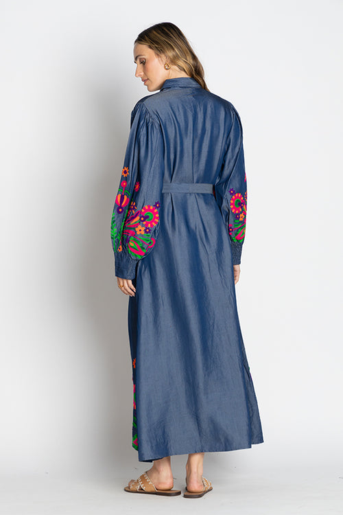 Back view of the Rubyyaya Gokarna Maxi Dress on a model, styled with the separate self-tie belt to define the waist, showcasing the long flowy silhouette and detailed embroidery on breathable cotton fabric.
