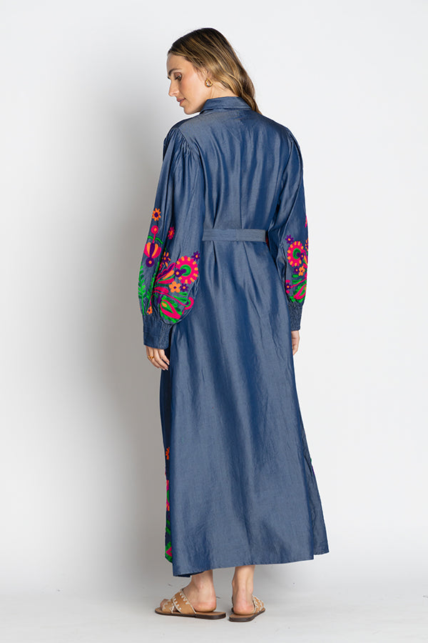 Back view of the Rubyyaya Gokarna Maxi Dress on a model, styled with the separate self-tie belt to define the waist, showcasing the long flowy silhouette and detailed embroidery on breathable cotton fabric.