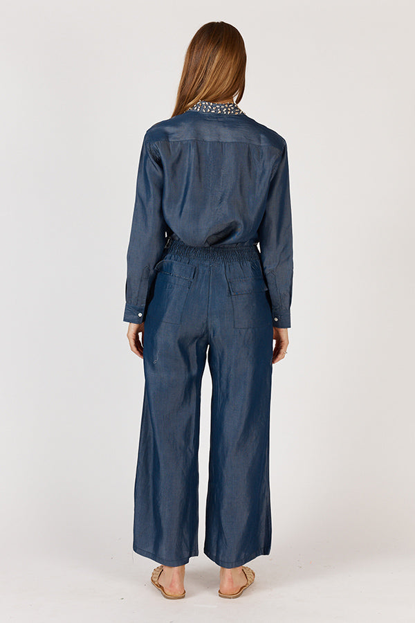 Back view of the Rubyyaya Jonson Shirt on a model, highlighting the shoulder yoke and relaxed fit of the denim cotton shirt with full-length sleeves.