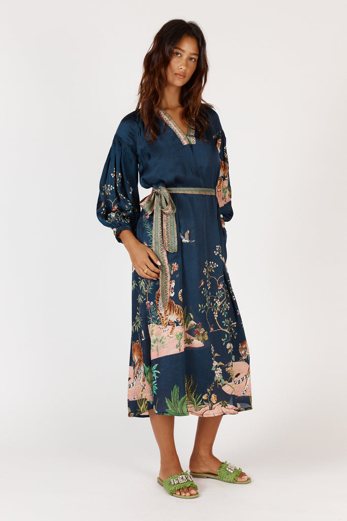 Side view of Rubyyaya Machali Maxi Dress on model, highlighting side pockets and soft drape of viscose satin fabric.