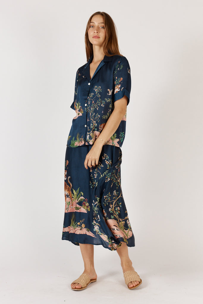 Woman wearing RubyYaya Machali Shirt Navy in exclusive print, front full length view, short sleeve button-through design.